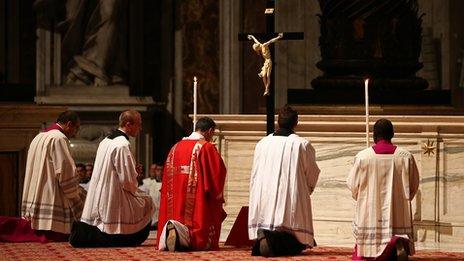 Bishops and priests pray under a crucifix (29 March 2013)