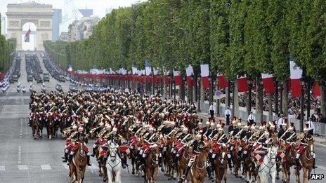 French Republican Guard ride their horses down the Champs-Elysees during the annual Bastille day parade in Paris on 14 July 2011