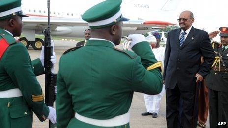 Sudan's President Omar al-Bashir reviews the troops as he arrives at the Nnamdi Azikiwe International Airport in Abuja on 14 July 2013