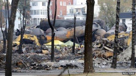 An emergency worker stands on the site of the train wreck in Lac Megantic 16 July 2013