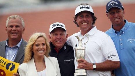 Phil Mickelson poses for pictures with his coach Butch Harmon (C), manager Steve Loy (L), caddie Jim Mackay (R) and wife Amy