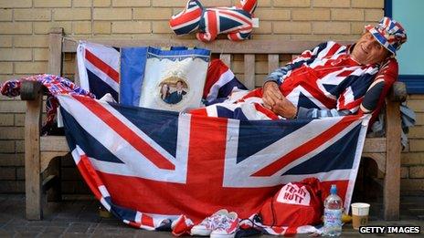 Royal supporter Terry Hutt poses for pictures on a bench where he has been camped out for 9 days outside the Lindo Wing