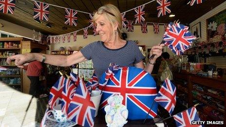 Linda Roberts dresses her windows with flags at Ye Olde King's Head English pub's gift shop in Santa Monica, California, to celebrate the royal baby's birth on 22 July 2013
