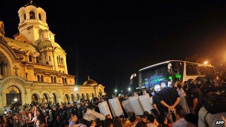 Protesters in front of Bulgaria's parliament block a bus trying to leave the building