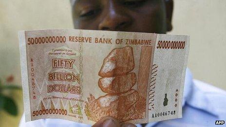 A Zimbabwean looks at a Z$50bn note issued by Zimbabwe's central bank on 13 January 2009
