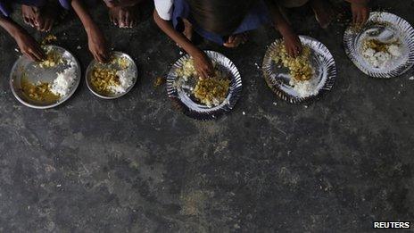Schoolchildren eat their free Mid-Day meal, distributed by a government-run primary school at Brahimpur village in Chapra district of Bihar state on July 19, 2013