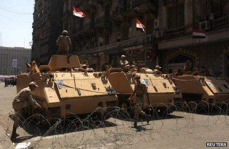 Armoured vehicles stand near Tahrir Square in Cairo, 26 July