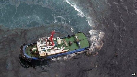 In this photo taken 27 July 2013, a cleaning vessel clears the oil after about 50 tons of crude oil was leak from a pipe spilled into the sea off Rayong province, eastern Thailand