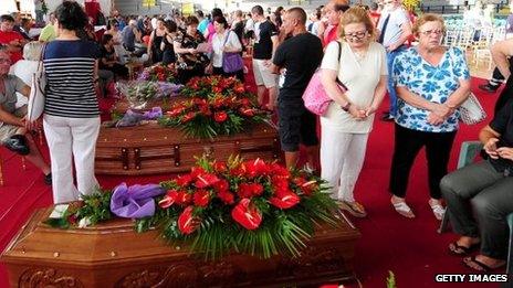 On July 30, 2013, relatives gather to grieve near to the coffins of the victims of the Monteforte Irpino coach crash.