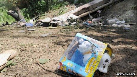 A view of a toy lies on the ground among the debris after a coach plunged from a flyover on the A16 motorway between Monteforte Irpino and Baiano on July 29, 2013 near Baiano, Italy.