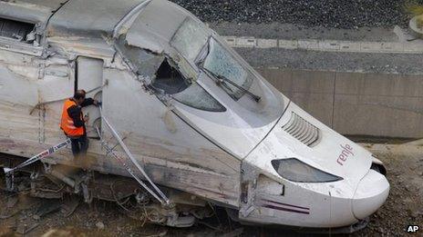 In this July 25, 2013 file photo, a rail personnel worker checks the cabin of a derailed train following an accident in Santiago de Compostela, Spain.