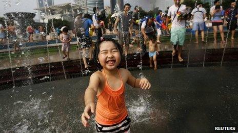 A girl participates in a water fight at People's Square in Shanghai, 21 July 2013