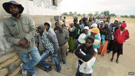 Zimbabweans wait in line as they prepare to cast their ballots at a polling station 60km north of Harare