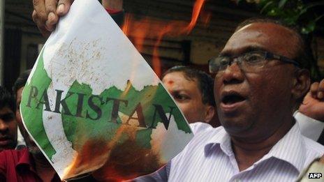 Activists burn a poster representing the map of Pakistan during a protest against the killing of 5 Indian soldiers in Kashmir, in Mumbai on August 7, 2013