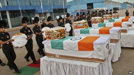 Indian soldiers pay tribute to their colleagues at a wreath laying ceremony at the Palam Technical Airport in Delhi, on August 7, 2013