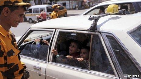 Policeman checks a taxi at a checkpoint in Sanaa 08/08/2013