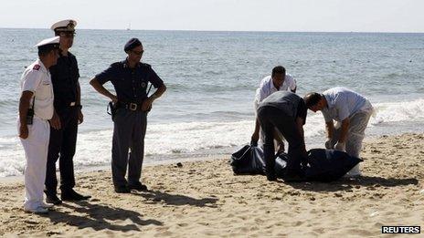 Italian police recover a body from La Playa beach in Catania, Italy, 10 August 2013