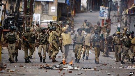 Indian paramilitary soldiers patrol during a protest against the state government after rival communities clashed in Kishtwar, in Jammu, India, Saturday, Aug. 10,2013