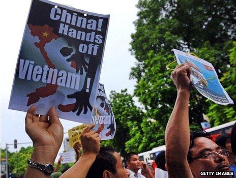 Vietnamese protesters hold up anti-China posters