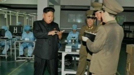 Kim Jong-un looks at smartphone