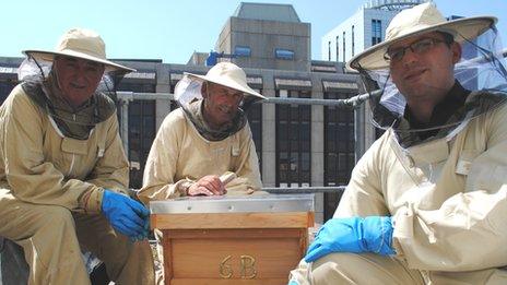 Steve Harris (l) and Scott Frankton (r) from the Royal Hotel pictured with bee keeper Peter Shaw by the Royal Hotel hive