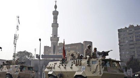 Egyptian Army soldiers stand guard outside the Rabaah al-Adawiya mosque, 16 August 2013
