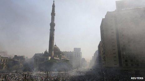 Smoke rises near the al-Fath Mosque during clashes at Ramses Square in Cairo, 16 August, 2013.