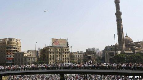 A military helicopter flies above supporters of ousted Egyptian President Mohammed Morsi, in Cairo 16 August, 2013.