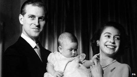 Prince Charles aged six months, pictured with his parents at Buckingham Palace