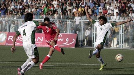Players compete during the soccer match between Afghanistan and Pakistan at the Afghanistan Football Federation stadium in Kabul