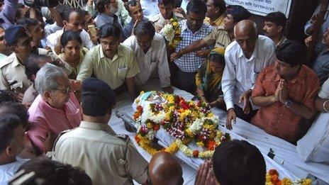 In this Tuesday, Aug. 20, 2013 photo, people pay last respects to anti-superstition activist Narendra Dabholkar who was killed in Pune, India