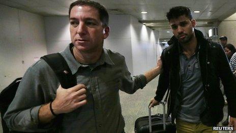 Glenn Greenwald (left) and his partner David Miranda (right) were reunited when Mr Miranda arrived back in Brazil