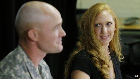 Shannon Carter, right, looks at her husband, US Army Staff Sgt Ty Carter, left, as he talks to reporters, at Joint Base Lewis-McChord in Washington state, on 29 July 2013