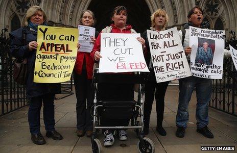 Protesters against the bedroom tax stand outside the High Court