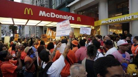 Protesting fast food workers demonstrate outside a McDonald's restaurant on New York's Fifth Avenue 29 August 2013