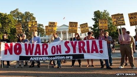 Anti-war protestors hold signs