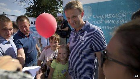 Alexei Navalny, centre, poses for a photo in downtown Moscow on 21 August
