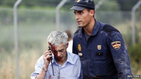 Francisco Jose Garzon helped away by policeman. 24 July 2013