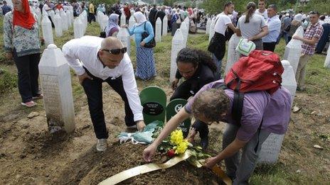 Dutch soldiers ex-members of UN mission to Safe enclave of Srebrenica at the graveside of baby Muhic during a mass funeral for Srebrenica victims at the memorial centre in Potocari, near Srebrenica, 160 kms east of Sarajevo, Bosnia, on 11 July 2013.