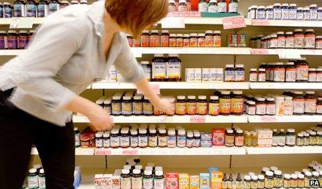 Woman buys health supplements in shop