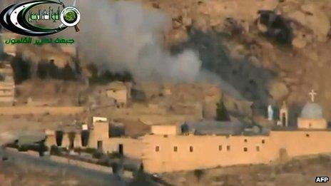 An online video from a rebel group shows smoke rising from the St Sarkis monastery after shelling (6 September 2013)