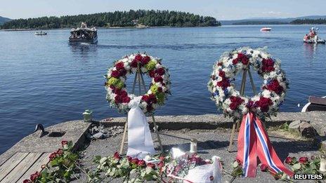 Wreaths to mark the two year anniversary of the massacre, with the island of Utoeya in the background (22 July 2013)