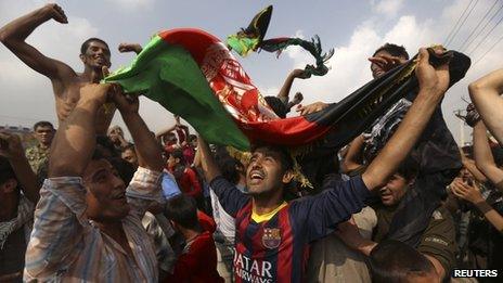 Afghan football fans celebrate winning the South Asian Football Federation championship after their team defeated India during the final match, in the streets of Kabul on 12 September 2013.