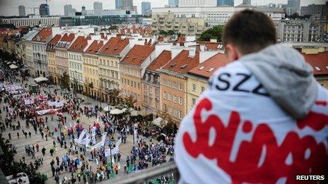 A protester from the Solidarity trade union looks down as people gather for an anti-government protest in central Warsaw