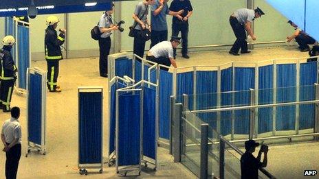 File photo: Chinese security personnel investigate the scene of the blast at Beijing's international airport terminal 3 on 20 July 2013