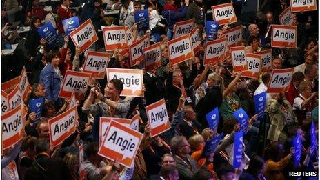 Supporters hold up placards that read "Angie", the nickname of German Chancellor and conservative Christian Democratic Union (CDU) leader Angela Merkel