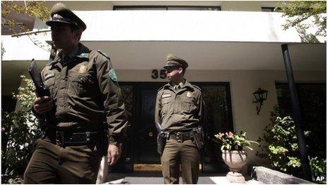 Officer stands guard outside the house Odlanier Mena killed himself