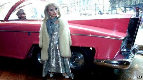 Two original Thunderbirds puppets, Lady Penelope and her chauffer Parker with FAB 1 the Rolls Royce are on display in a window in Central London