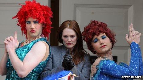 Julianne Moore with drag artists in red wigs