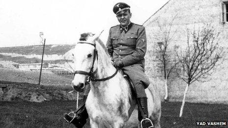 Amon Goeth in uniform, riding a horse